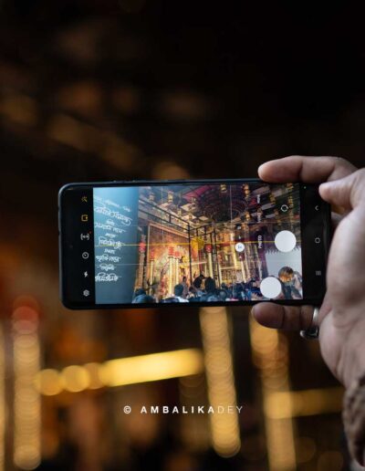 Smartphone capturing the Ballygunge Cultural Durga Puja pandal in Kolkata