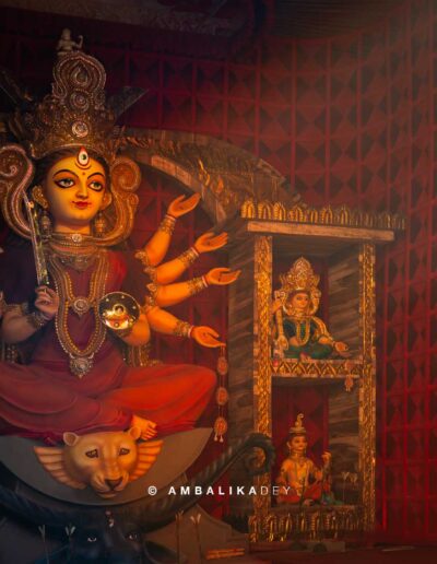 Durga idol illuminated inside a decorated Durga Puja pandal in Kolkata