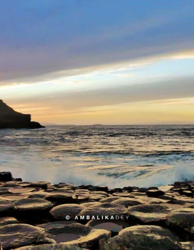Basalt columns of Giant's Causeway beside the Atlantic Ocean at sunset in Northern Ireland
