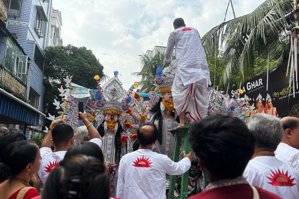 Members of Shobha Bajar Rajbari's Chhoto Taraf accompany the Durga idol through the historic streets of North Kolkata during the Vijaya Dashami procession.
